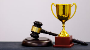 Judge's,Gavel,And,Trophy,On,White,Background.,Symbol,For,Jurisdiction.
