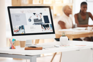 Graphic design, website and marketing with a screen for advertising campaign on a computer in a creative office. Designer, brand and editor in a studio for product placement, art and creativity