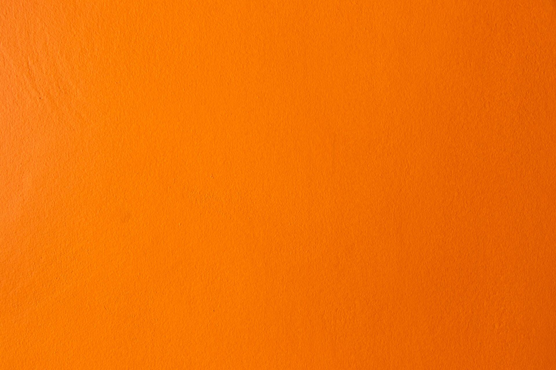 Orange color of grunge concrete textured background with copy space