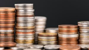 An assortment of stacked coins showcasing different sizes and colors, representing currency, wealth, and financial concepts.