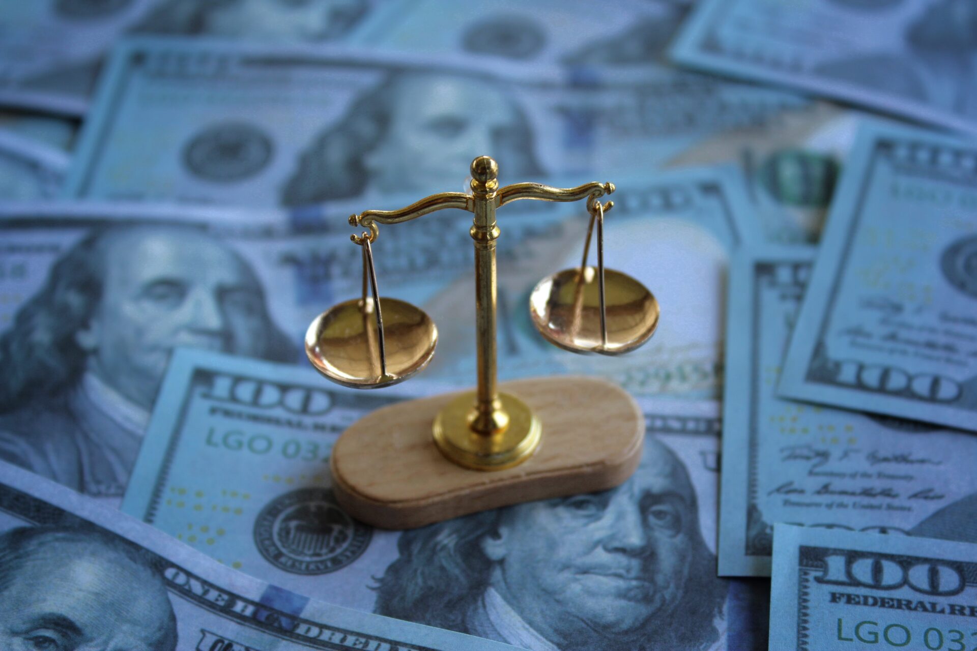 Balancing scale on top of money. Law, bribery, justice and corruption concept