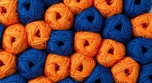 organized balls of orange and blue yarn, background pattern, knitting and crafting graphic